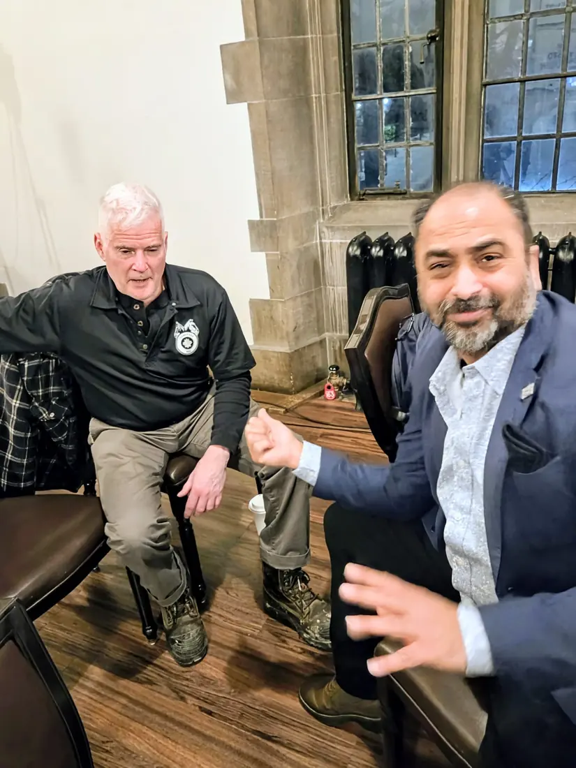Husain at a community event indoors