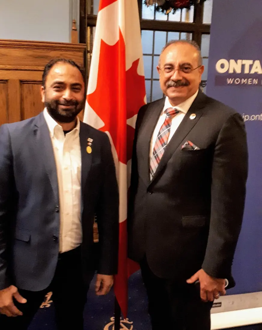 Husain with a dignitary at an Ontario PC event