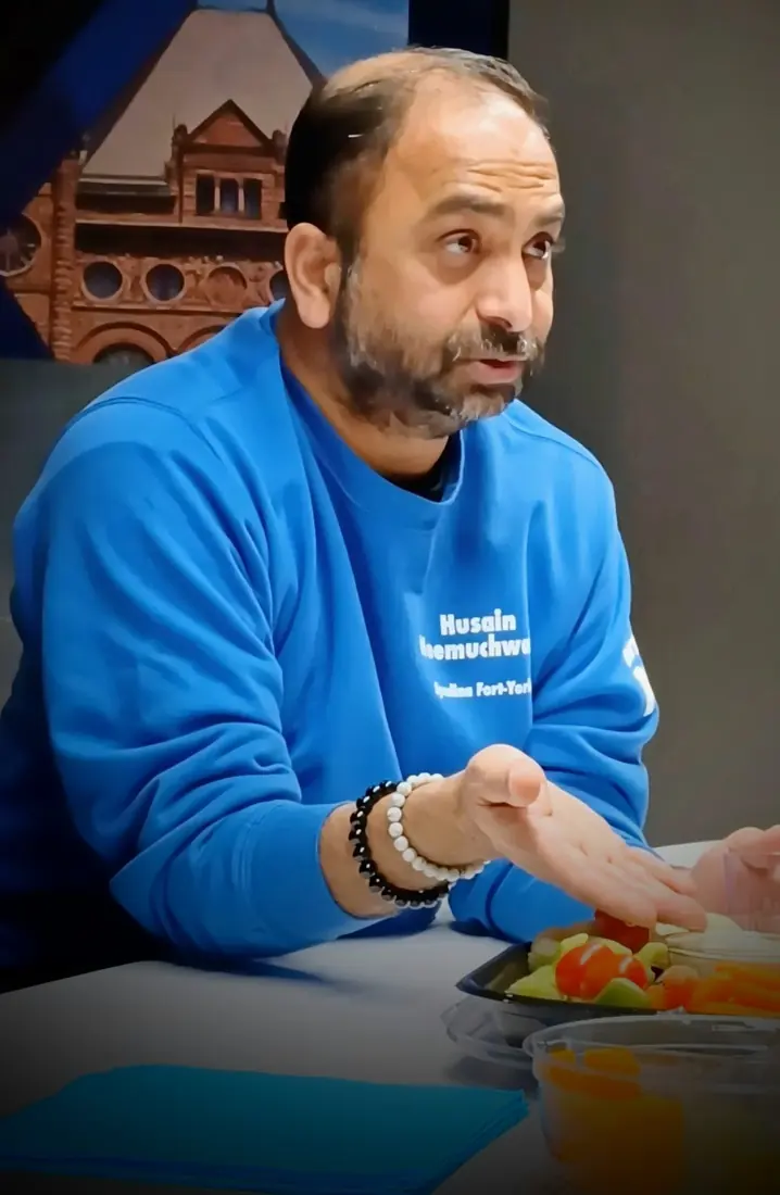 Husain speaking at a campaign event in Spadina-Fort York